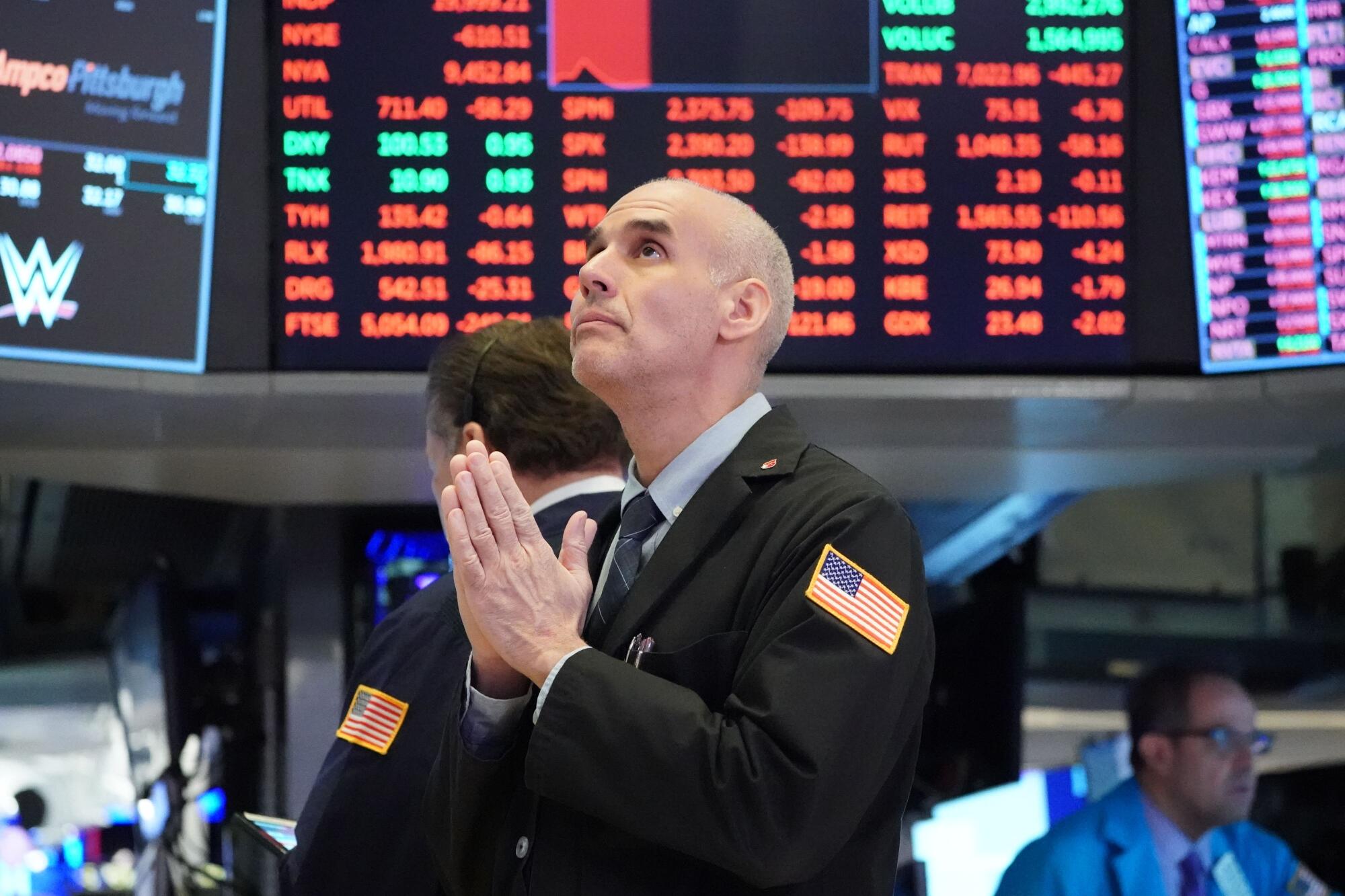 Traders work on the floor of the New York Stock Exchange on March 18.