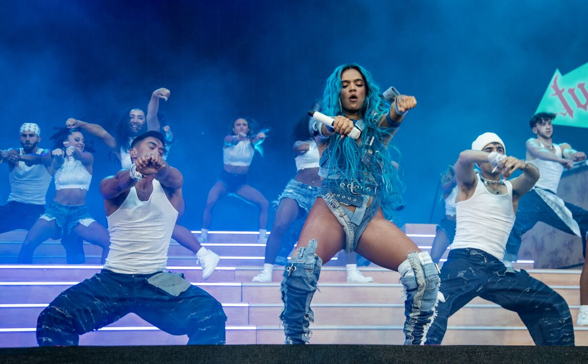 With her bright blue hair, Karol G performs with two dancers on Coachella's main stage.