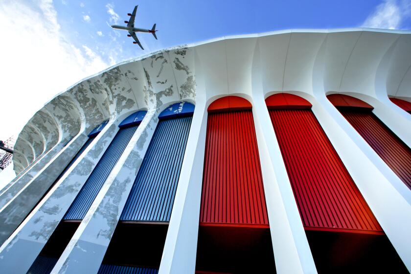 A multimillion-dollar revitalization of the Forum in Inglewood includes restoring the building's Roman-inspired columns and repainting the metal panels "California sunset red."