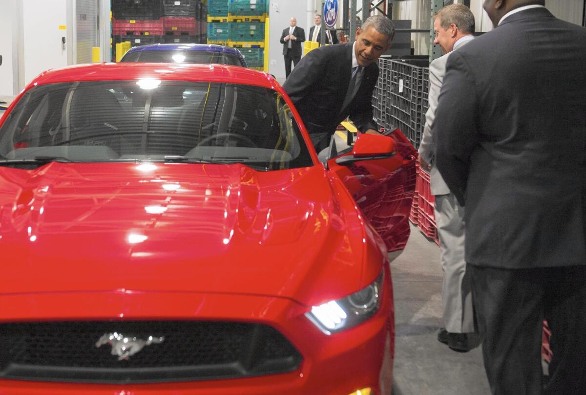 President Obama checks out a Mustang before speaking on the auto industry and U.S. economy at Ford's Michigan Assembly Plant in Wayne, Mich.