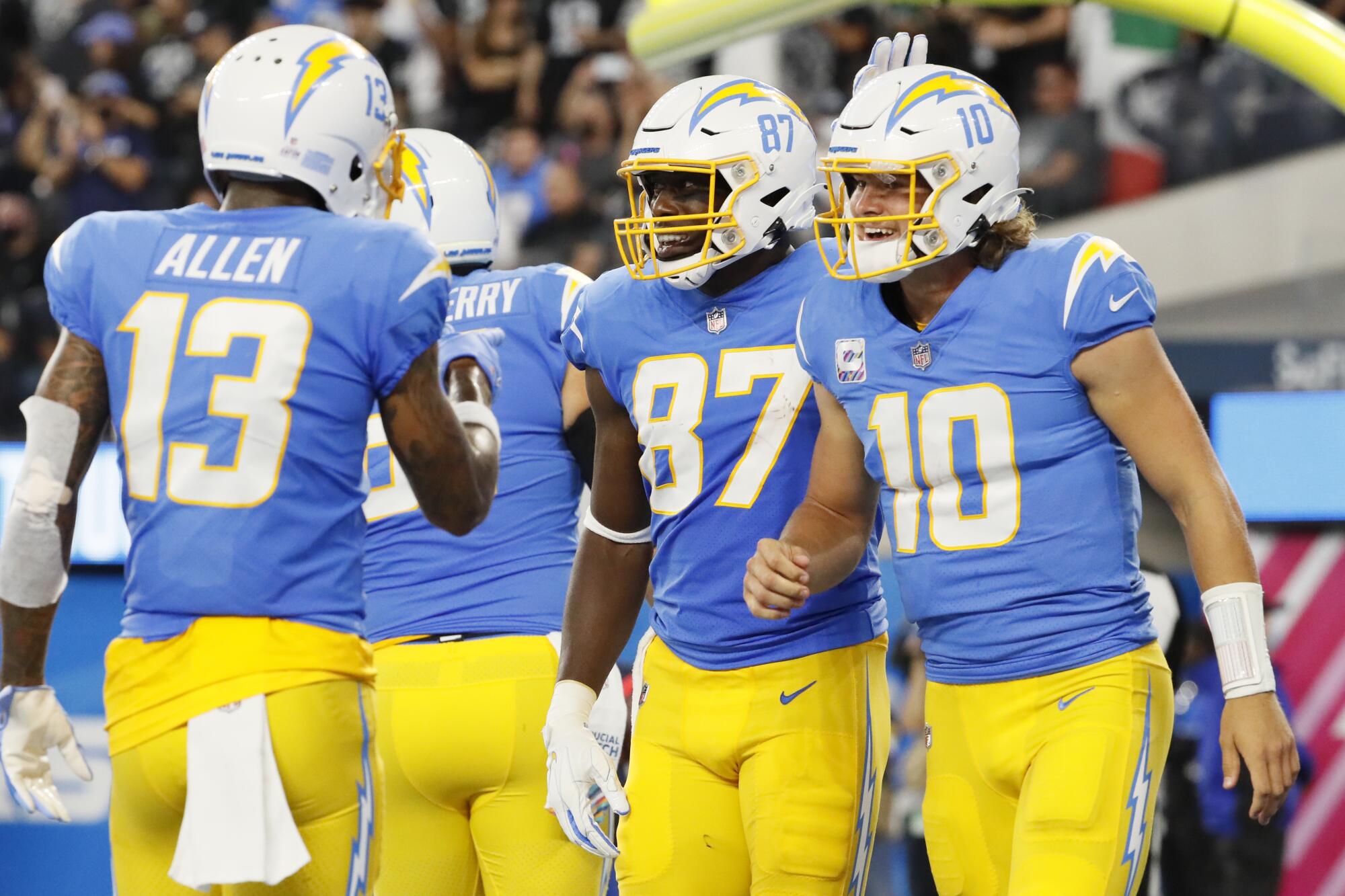 Chargers quarterback Justin Herbert celebrates with teammates after throwing a touchdown pass to tight end Jared Cook.