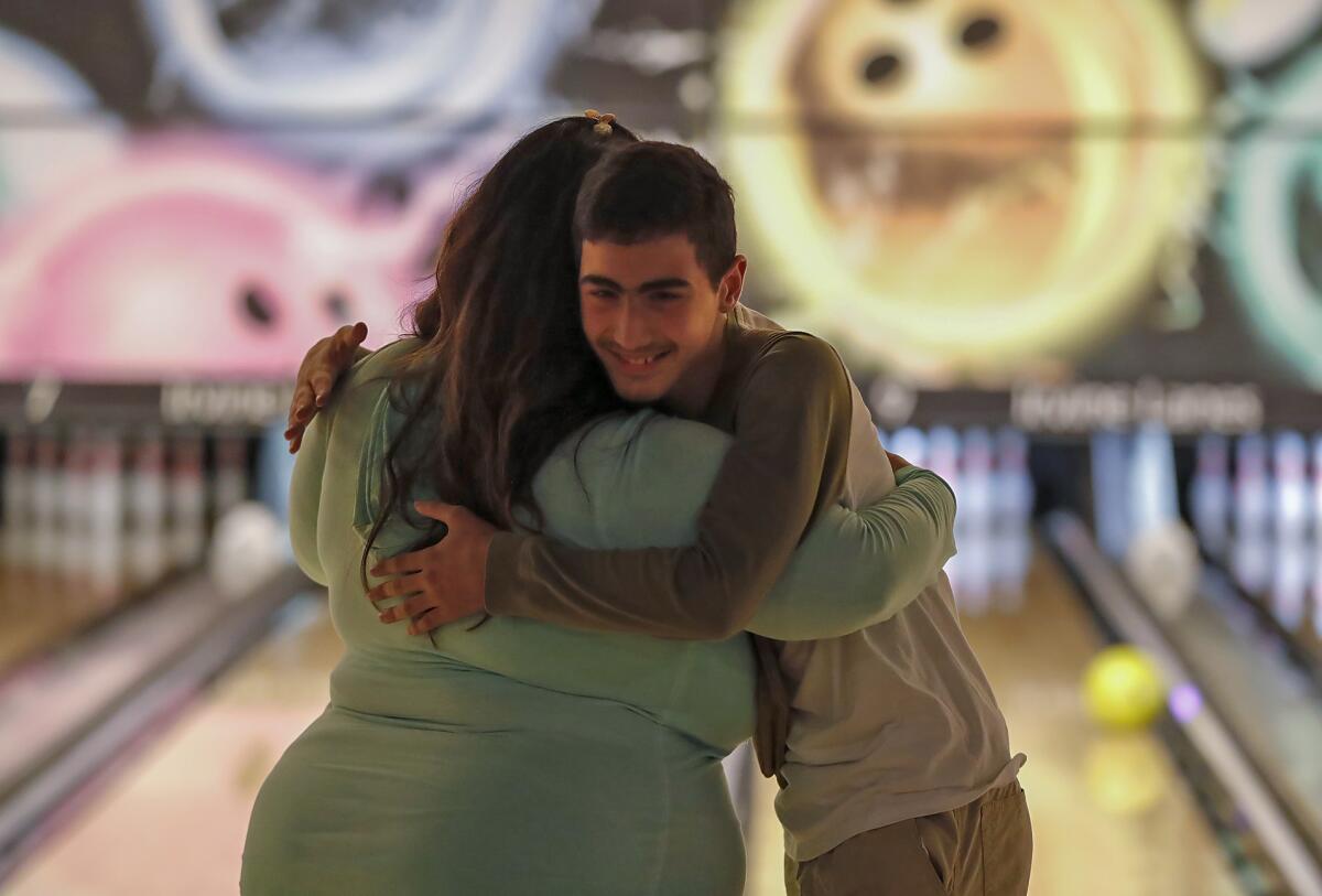 Nicole Fusaro hugs one of her students during an outing at the Irvine Lanes.