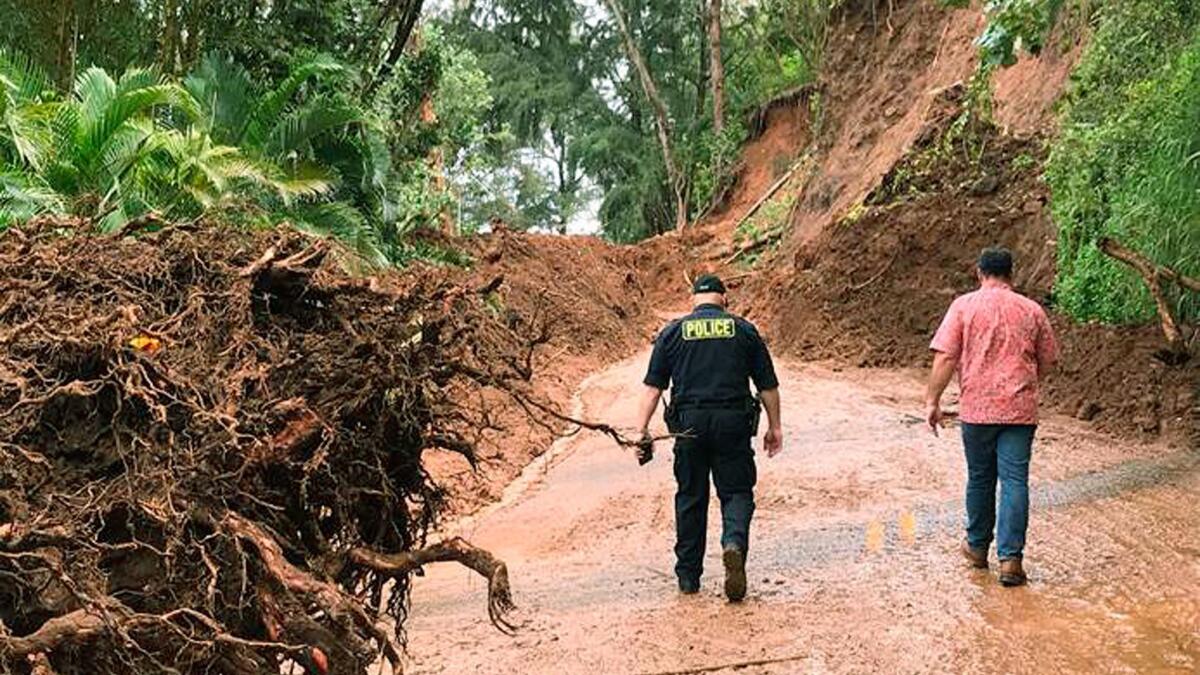 Officials survey damage last Thursday from a recent storm on the island of Kauai that left the area temporarily flooded. Tourism officials tell travelers it's safe to visit popular places such as Hanalei.