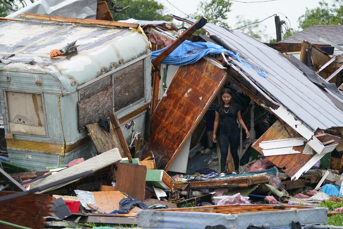 A person stands outside a Texas home that was damaged by a tornado.