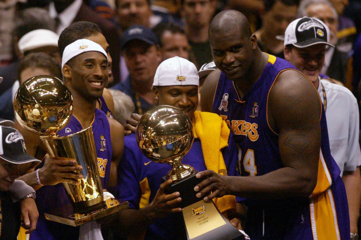 Lakers Kobe Bryant, left, Lindsey Hunter and Shaquille O'Neal just after winning the NBA tile in 2002.