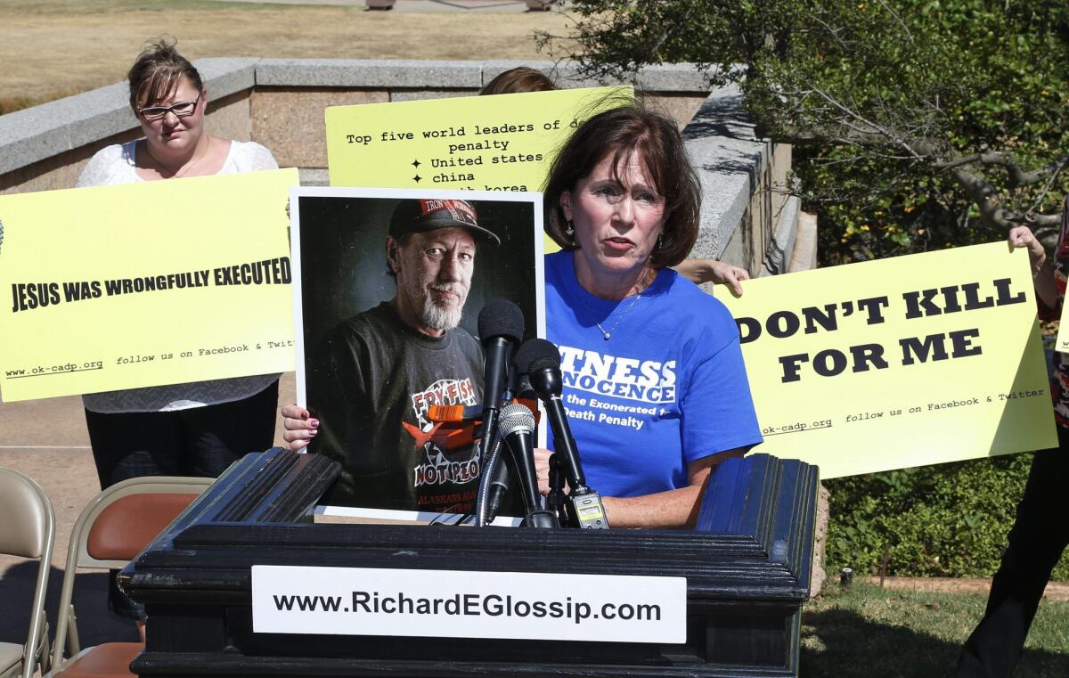 Nancy Vollertsen holds a photo of her brother, Greg Wilhoit, who spent five years on Oklahoma's death row before being exonerated. She was protesting the scheduled execution of Richard Glossip.