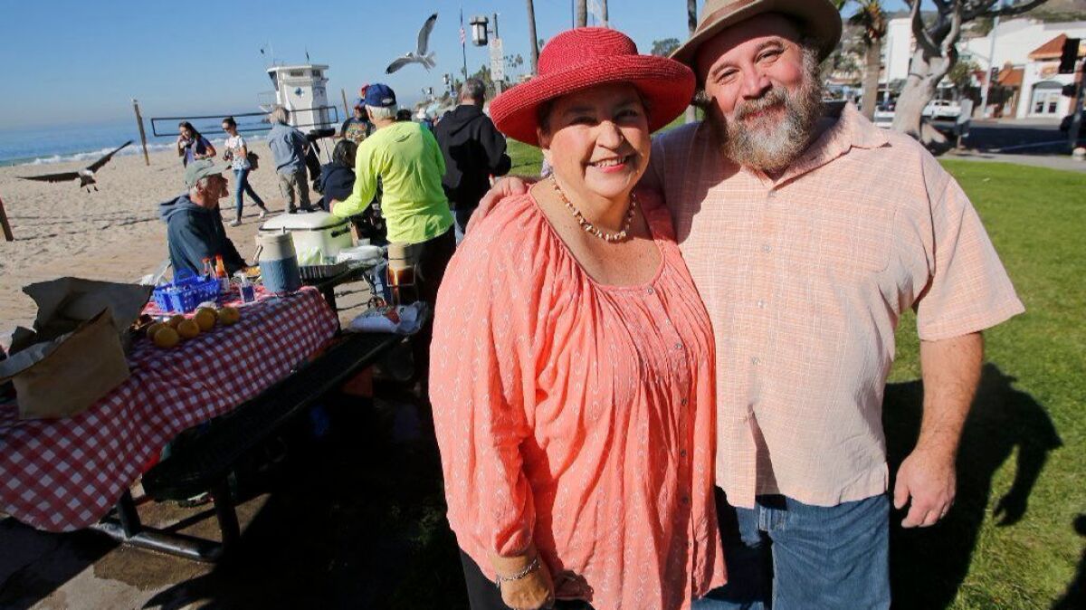Trish and Brad Miller offer a homeless outreach breakfast at Main Beach in Laguna Beach on Dec. 13.