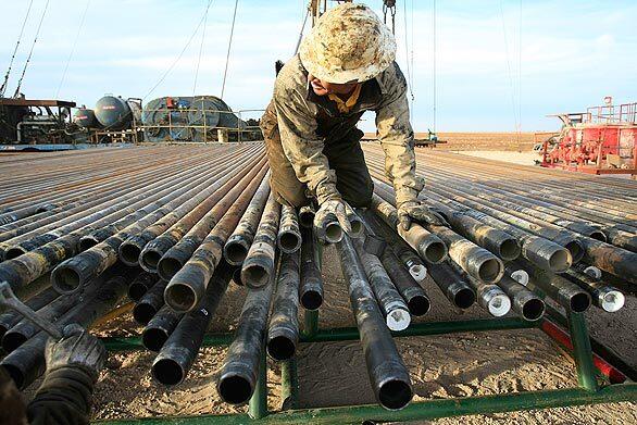 An oil rigger prepares pipes for drilling at the Schlumberger field north of Midland, Texas -- a city where President-elect Obama is unlikely to have much of a honeymoon period.