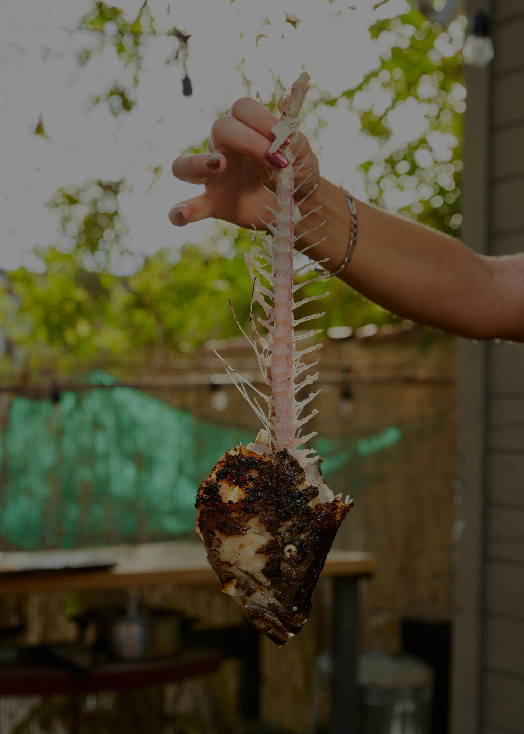 Karla Subero Pittol holds the fish after serving.