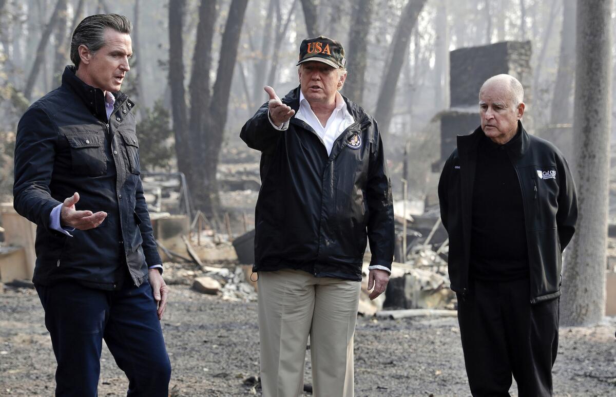 President Trump visits a neighborhood ravaged by the Paradise fire with Gov.-elect Gavin Newsom, left, and outgoing Gov. Jerry Brown in November.