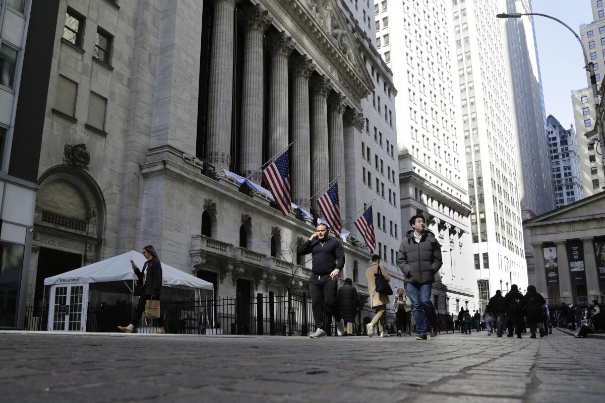 People pass the front of the New York Stock Exchange