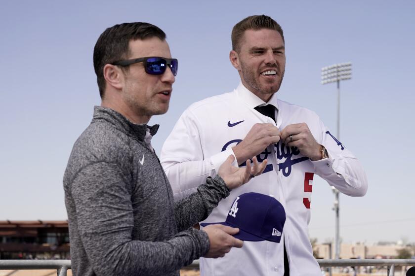 Dodgers president of baseball operations Andrew Friedman, left, announces the arrival of Freddie Freeman on March 18, 2022.