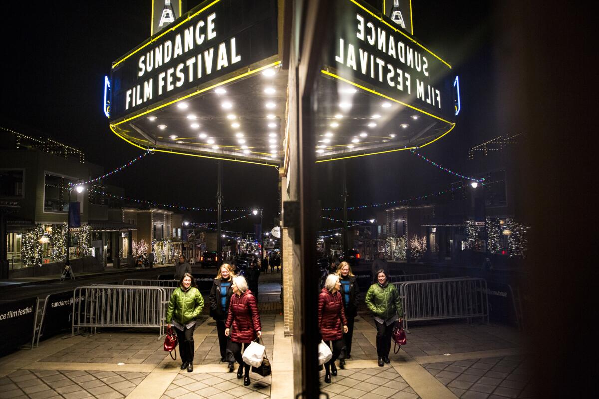 People walk past the Egyptian Theatre, a landmark venue showing films during the 2018 Sundance Film Festival.
