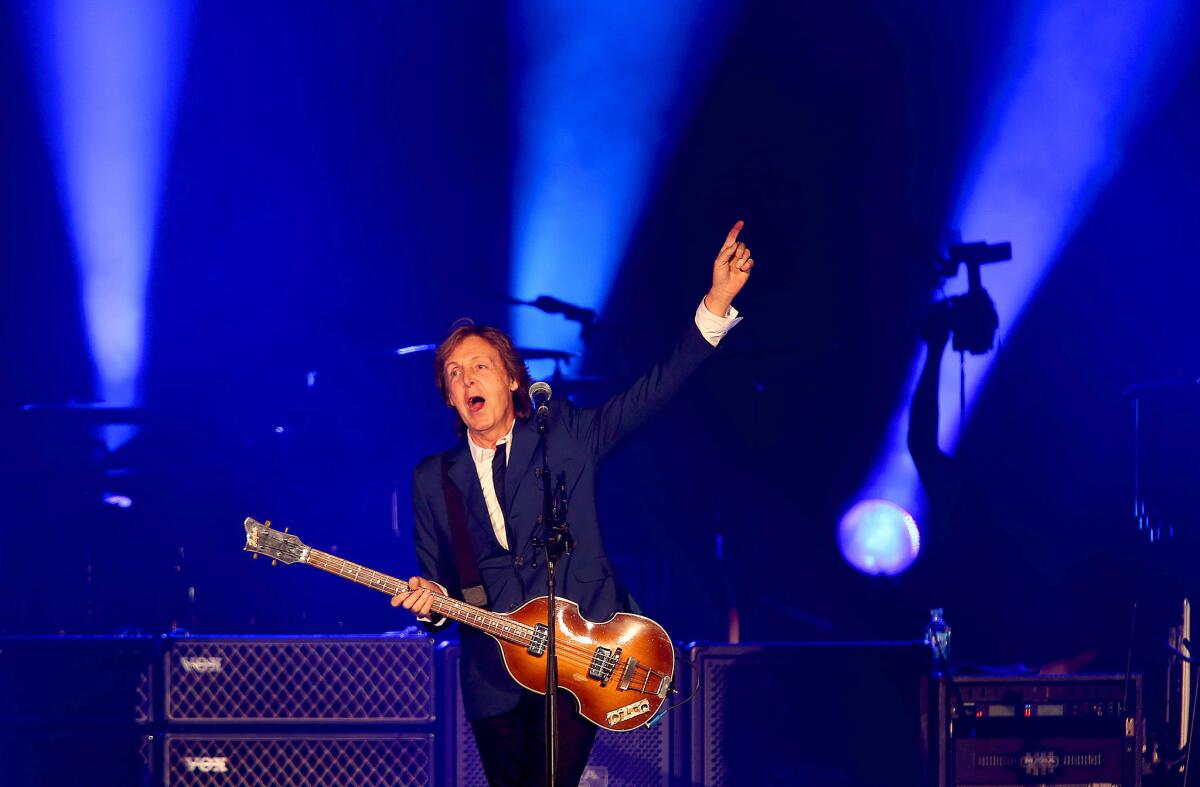 Paul McCartney greets the sold-out Dodger Stadium crowd before performing in Los Angeles on Sunday night. It was McCartney's first performance at the stadium since the Beatles played there 48 years ago.