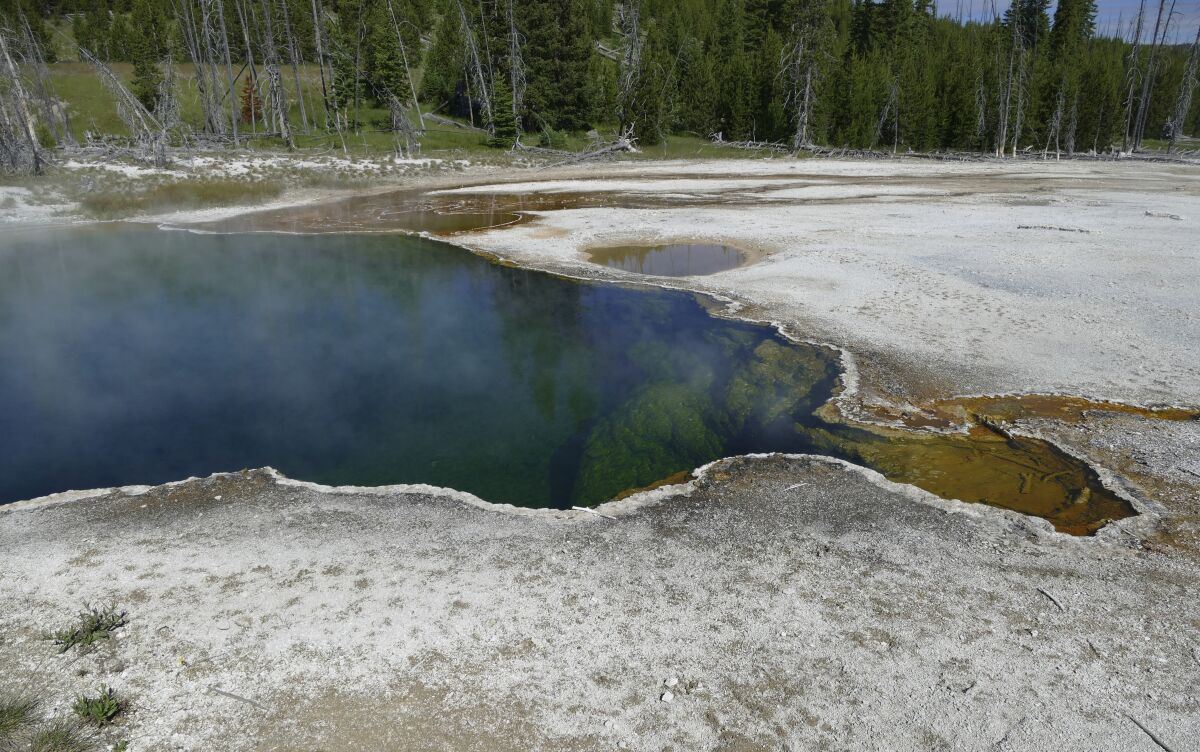 In this photo provided by the National Park Service is the Abyss Pool hot spring in the southern part of Yellowstone National Park, Wy., in June 2015. Park officials are investigating after part of a foot, in a shoe, was found floating in the hot spring on Tuesday, Aug. 16, 2022. (Diane Renkin/National Park Service via AP)
