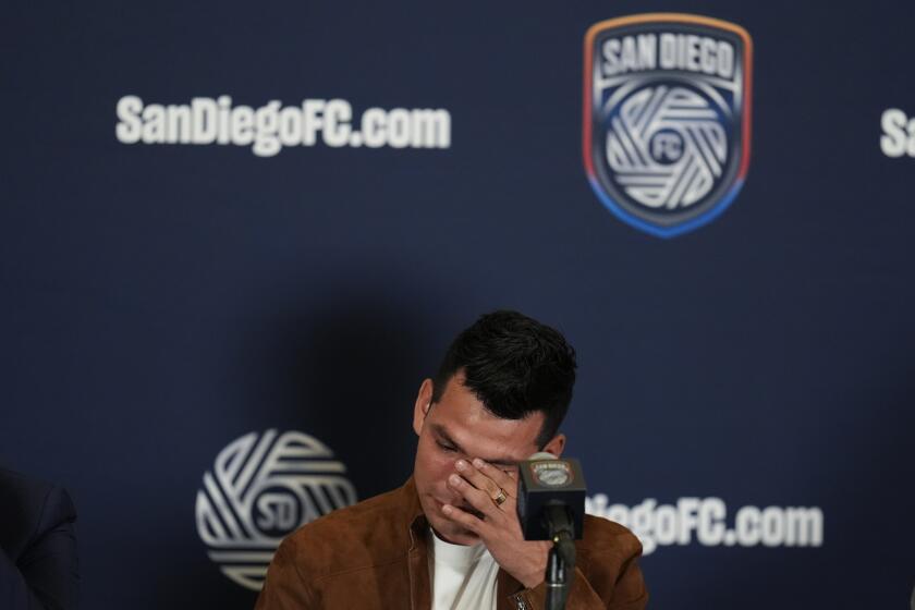Hirving "Chucky" Lozano wipes tears from his eyes during an introductory news conference for Lozano and the new MLS soccer team Thursday, June 13, 2024, in San Diego. The Mexican star will be part of San Diego FC's first season, when they join the MLS in 2025. (AP Photo/Gregory Bull)