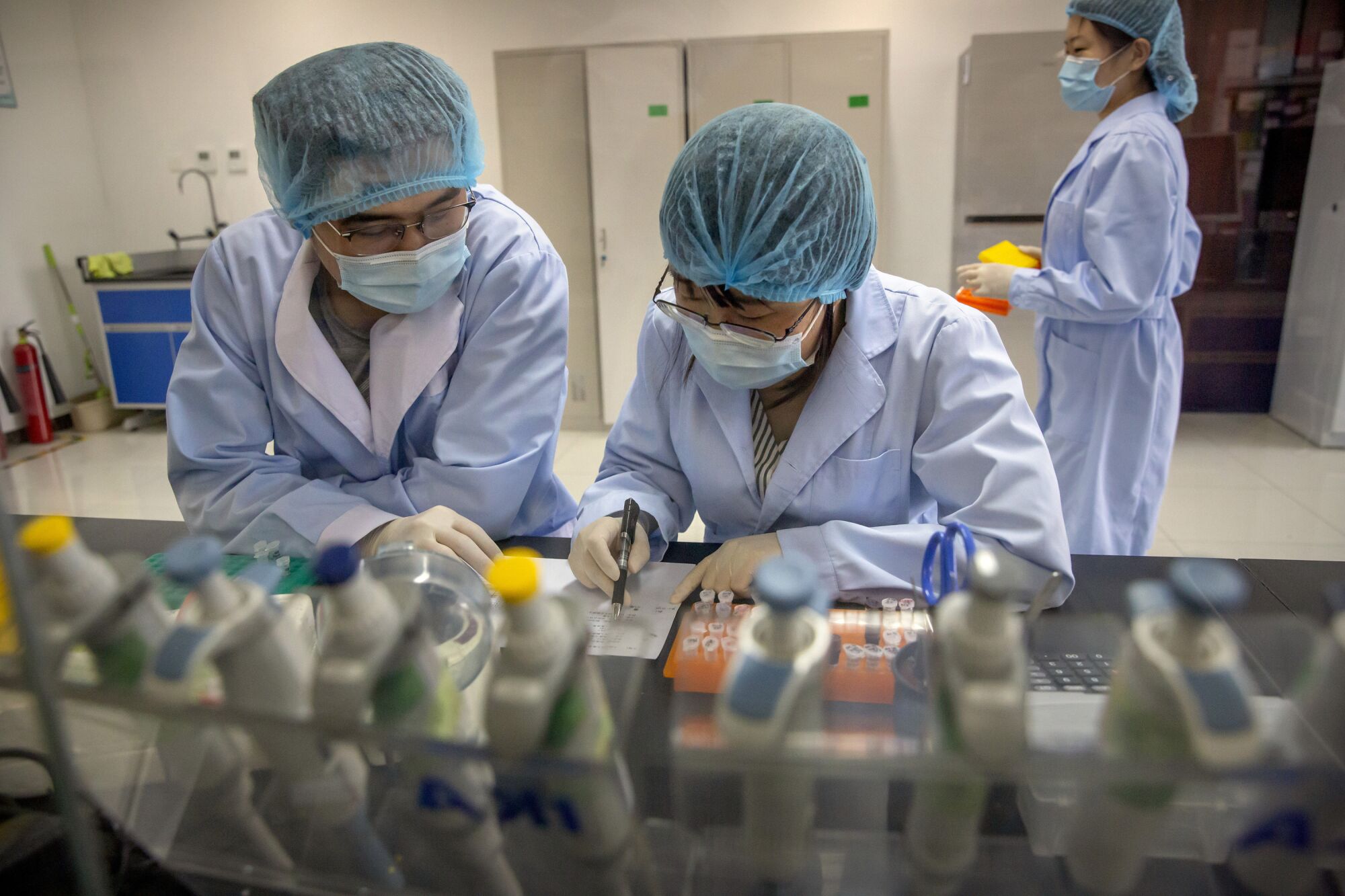 Employees work in a research and development lab of Beijing Applied Biological Technologies.