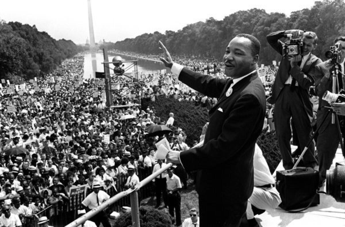 The Rev. Martin Luther King Jr. waves from the Lincoln Memorial on Aug. 28, 1963.