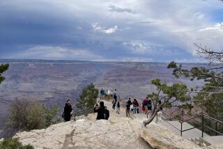 GRAND CANYON NATIONAL PARK, ARIZONA - SEPTEMBER 8, 2022: Visitors take photos and gather at lookout near Mather Point, at the South Rim of Grand Canyon National Park, on Thursday, September 8, 2022. The immense view across the Grand Canyon and the inner canyon, the Colorado River, and distant views of the North Rim are visible across the 10-mile expanse. The South Rim is the choice for first-time visitors looking for the classic Grand Canyon experience. It is the most accessible and most popular section of the canyon to visit. (Robbin Goddard / Los Angeles Times)