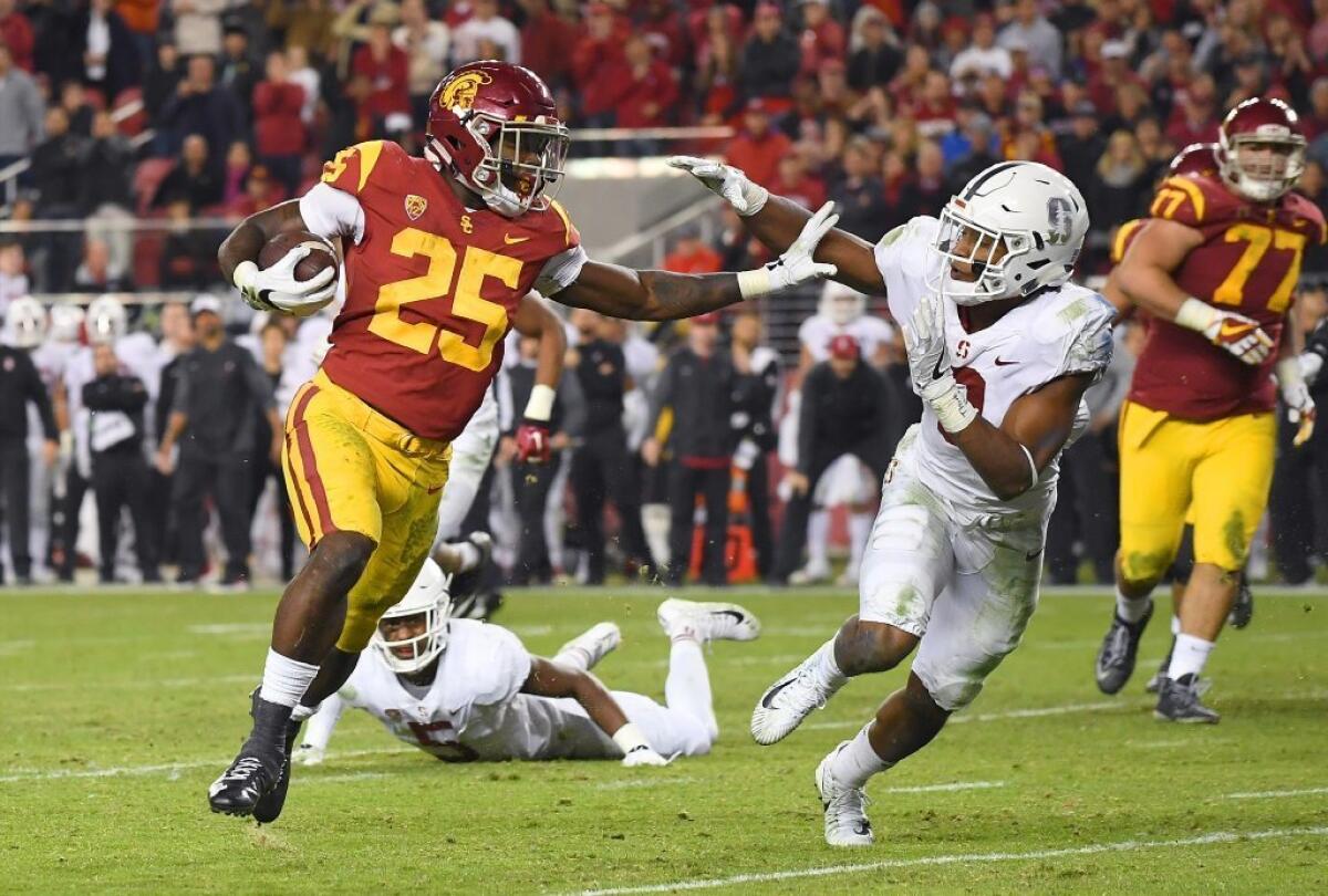 USC running back Ronald Jones II fights off a tackle attempt by Stanford's Justin Reid as he runs for an eight-yard touchdown during the Pac-12 championship game at Levi's Stadium on Dec. 1.