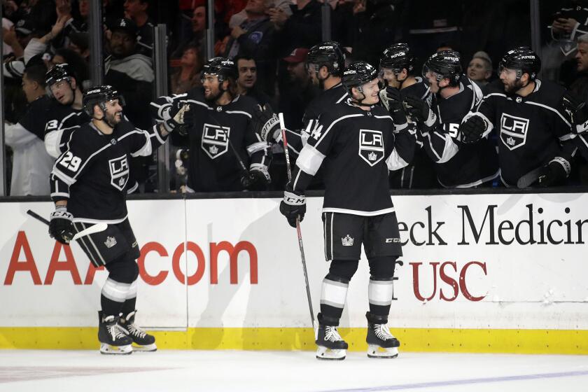 Los Angeles Kings' Mikey Anderson, right, celebrates his goal with teammates during the first period of an NHL hockey game against the Colorado Avalanche Monday, March 9, 2020, in Los Angeles. (AP Photo/Marcio Jose Sanchez)