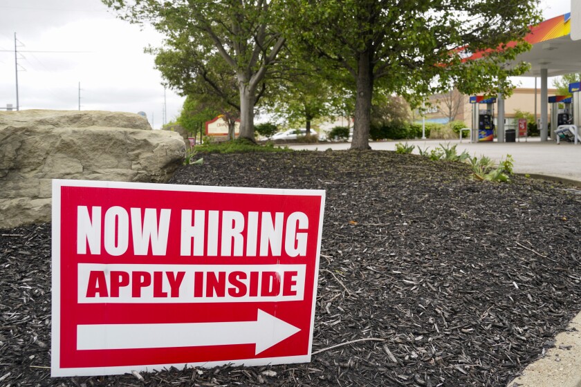 Hiring signs are posted outside a gas station in Cranberry Township, Butler County, Pa.,