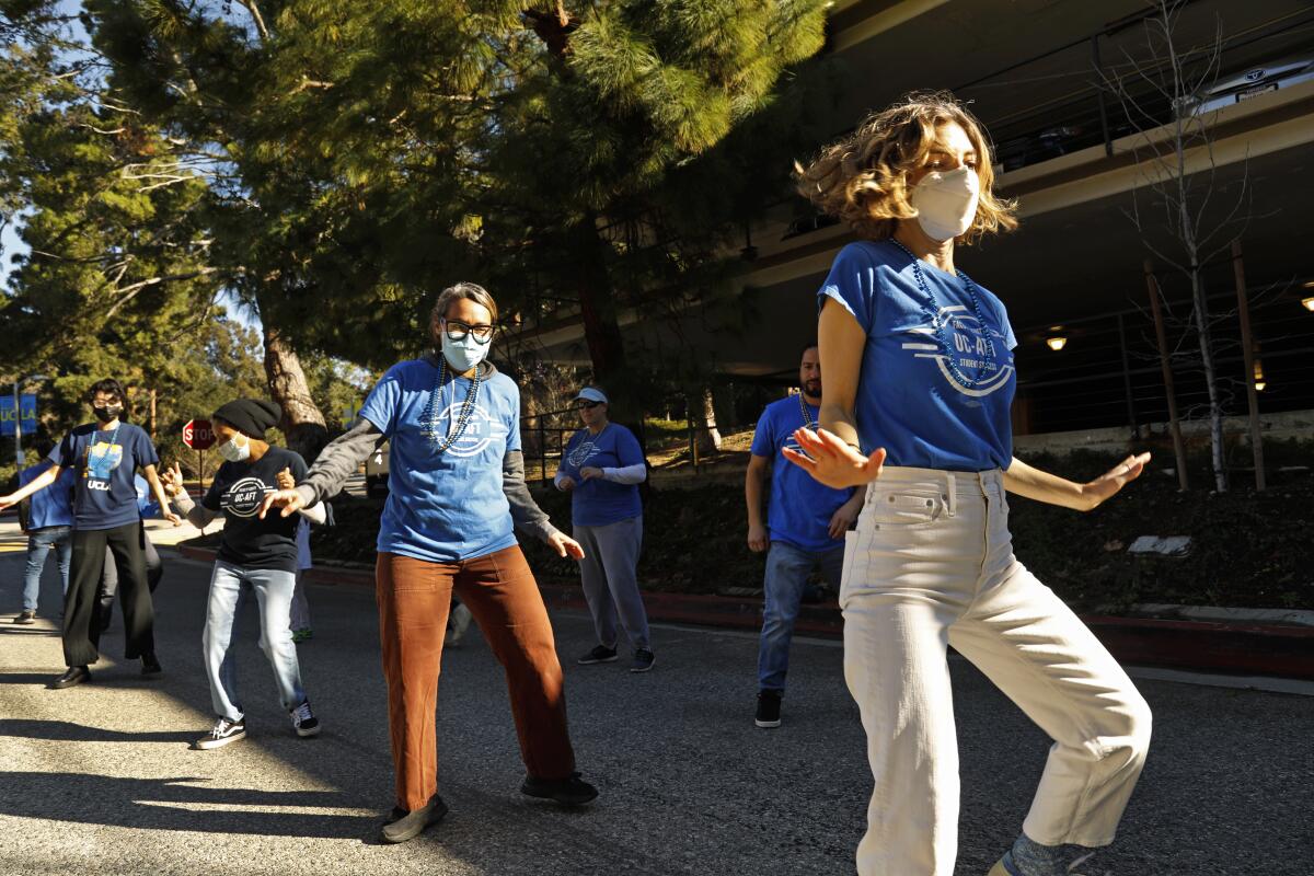 Cristina Paul, right, a dual language demonstration teacher, and others, takes part in a protest at UCLA lab. 
