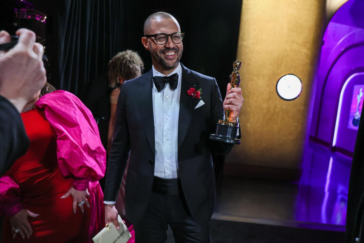 Cord Jefferson holds his adapted screenplay Oscar backstage Sunday at the Dolby Theatre in Hollywood 