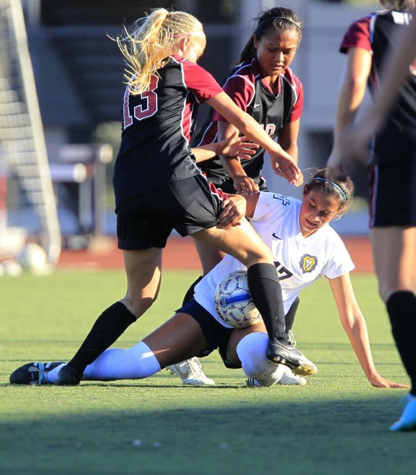 Vanguard's Kelsea Arenado, bottom, battles Westmont's Brooke Lillywhite, top left, and Tiffany Dimaculangan, top right, during the first half at Biola University in La Mirada on Tuesday.