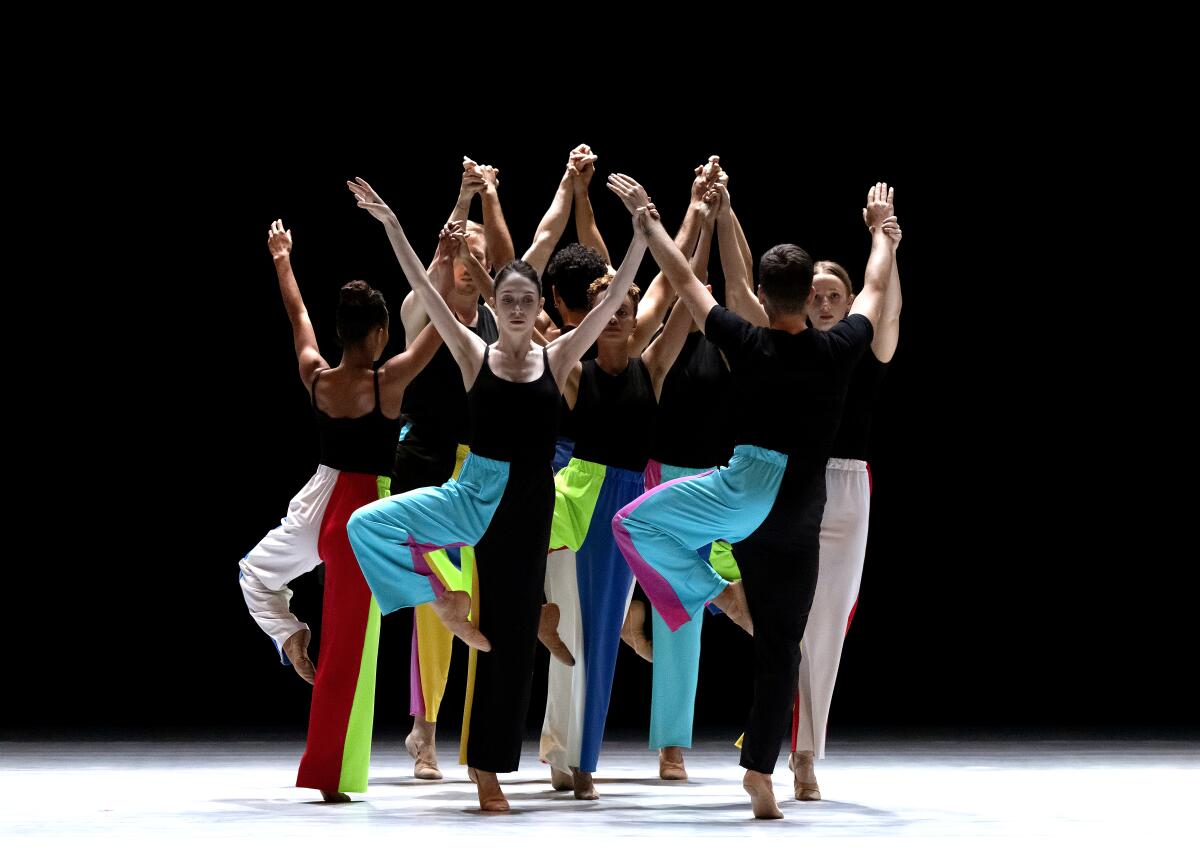 Dancers form a circle on stage. 