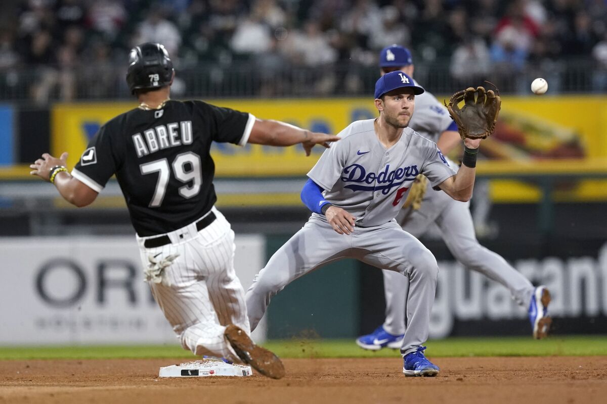 Dodgers' Trea Turner forces Chicago White Sox's Jose Abreu out at second on the throw from Justin Turner.