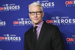 A man with white hair wearing glasses and a suit