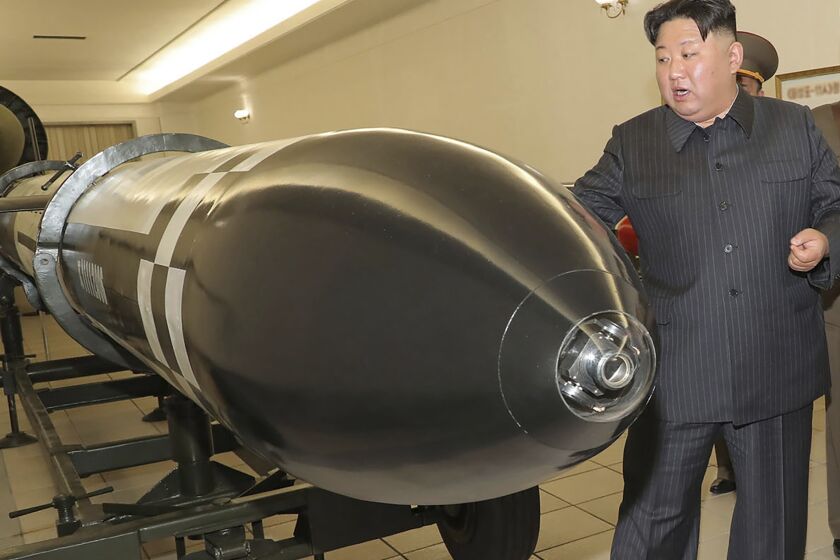This photo provided on Tuesday, March 28, 2023, by the North Korean government, North Korean leader Kim Jong Un, rear, visits a hall displayed what appeared to be various types of warheads designed to be mounted on missiles or rocket launchers on March 27, 2023, in undisclosed location, North Korea. Independent journalists were not given access to cover the event depicted in this image distributed by the North Korean government. The content of this image is as provided and cannot be independently verified. (Korean Central News Agency/Korea News Service via AP)