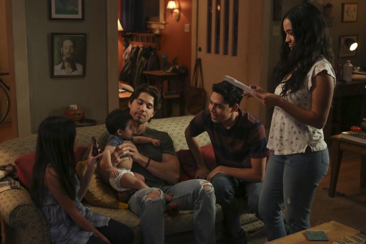 A still shows the five children of the Acosta family gathered around the living room couch 