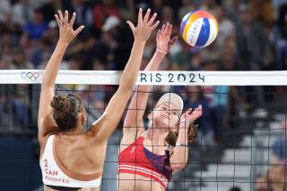 American Kristen Nuss hits a shot past Canada's Sophie Bukovec during beach volleyball match at the Olympics in Paris