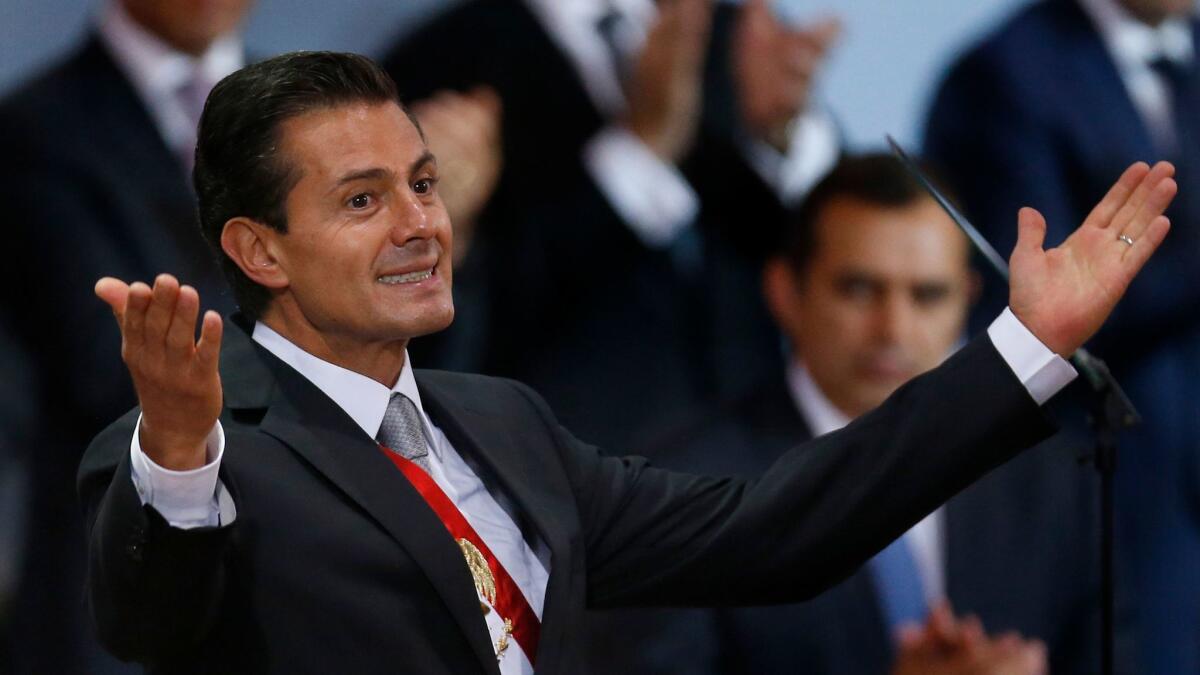 Mexican President Enrique Peña Nieto acknowledges invited guests before delivering his annual state of the union address at the National Palace in Mexico City on Saturday.