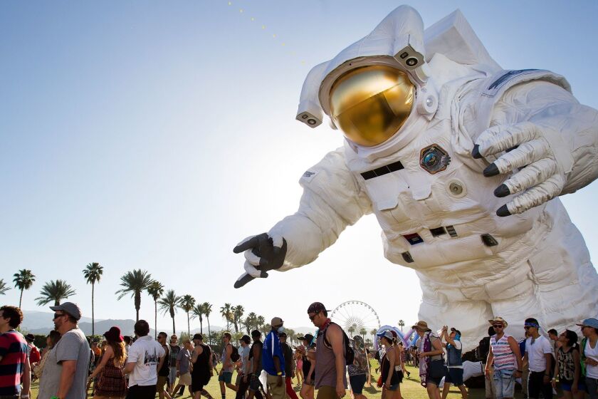 4/11//2014 Indio, California. | On the first day of the Coachella Valley Music and Arts Festival a sold out crowd got the party started. The moving art piece called Escape Velocity by Poetic Kinetics moves past the crowd. | photo Sean M. Haffey UT San Diego.