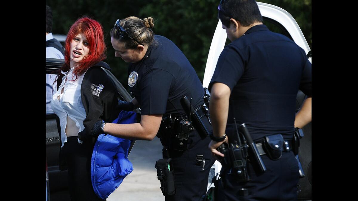 Police arrest someone who was in a car involved in a high-speed chase that started in Beverly Hills. The suspect is searched by an LAPD officer after being apprehended on Roxbury Drive in Beverlywood.