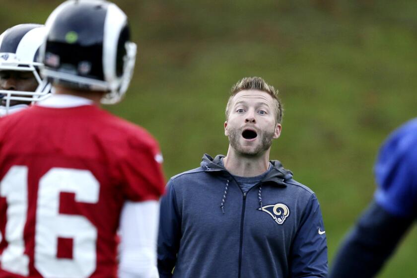 Los Angeles Rams' head coach Sean McVay, centre, speaks with Los Angeles Rams' quarterback Jared Goff, left, during a training session at Pennyhill Park Hotel in Bagshot, England, Friday Oct. 20, 2017. The Los Angeles Rams are preparing for an NFL regular season game against the Arizona Cardinals in London on Sunday. (AP Photo/Tim Ireland)