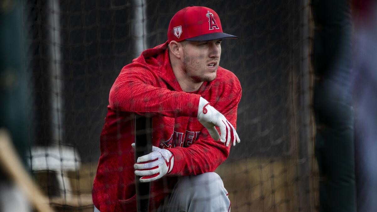 Mike Trout takes a knee in the batting cage during spring training Feb. 18 at Tempe Diablo Stadium in Tempe, Ariz.