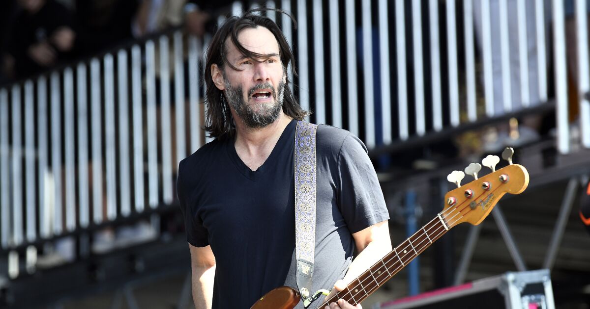 Woaah, that’s no air guitar. Keanu Reeves grabs his bass for a rare Dogstar reunion