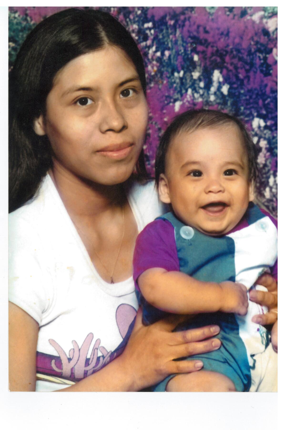 Gloria Tovar, holding a baby