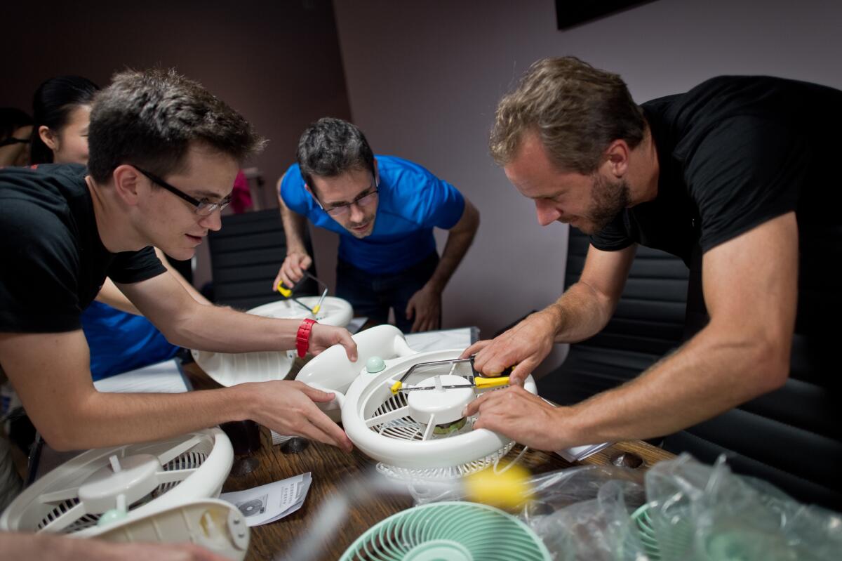 Thomas Talhelm, center, led workshops in Beijing to demonstrate how to make a simple, DIY air purifier.