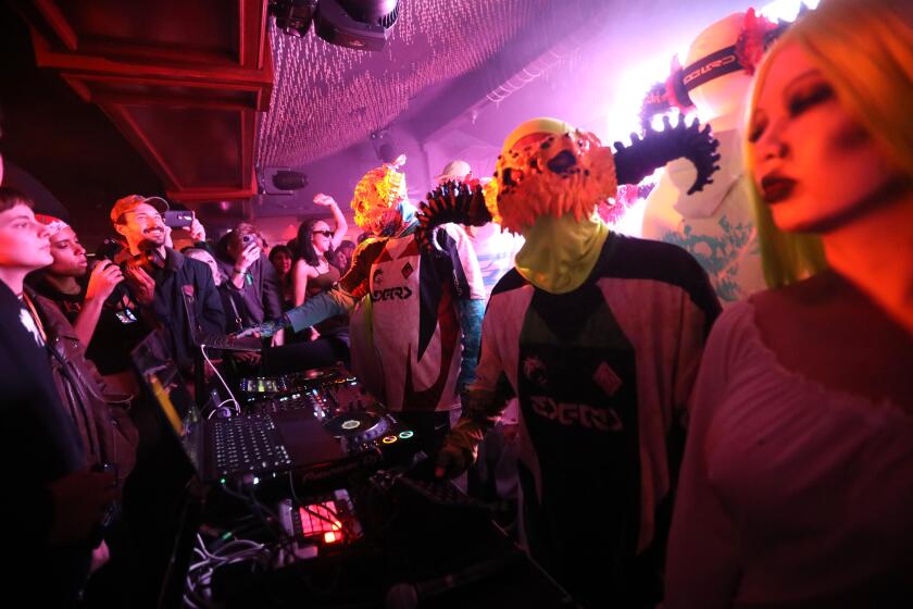 HOLLYWOOD, CA - FEBRUARY 7, 2024 - - Director Harmony Korine, second from right, DJ's as he and others dress as characters from his new experimental film, "Aggro Dr1ft," after the movie's premiere at Crazy Girls strip club in Hollywood on February 7, 2024. (Genaro Molina/Los Angeles Times)