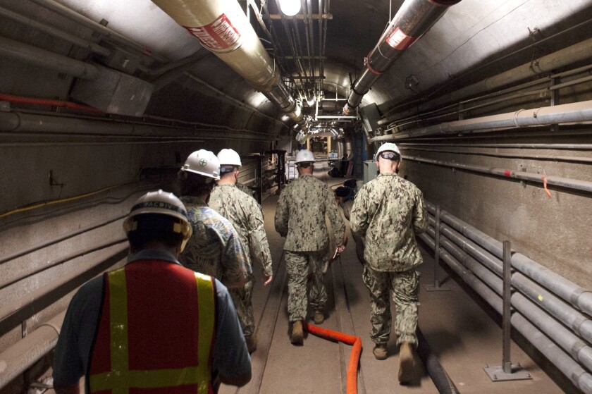 FILE - In this Dec. 23, 2021, photo provided by the U.S. Navy, Rear Adm. John Korka, Commander, Naval Facilities Engineering Systems Command (NAVFAC), and Chief of Civil Engineers, leads Navy and civilian water quality recovery experts through the tunnels of the Red Hill Bulk Fuel Storage Facility, near Pearl Harbor, Hawaii. A Navy investigation released Thursday, June 30, 2022 revealed that shoddy management and human error caused fuel to leak into Pearl Harbor's tap water last year, poisoning thousands of people and forcing military families to evacuate their homes for hotels. The investigation is the first detailed account of how jet fuel from the Red Hill Bulk Fuel Storage Facility, a massive World War II-era military-fun tank farm in the hills above Pearl Harbor, leaked into a well that supplied water to housing and offices in and around Pearl Harbor. (Mass Communication Specialist 1st Class Luke McCall/U.S. Navy via AP, File)