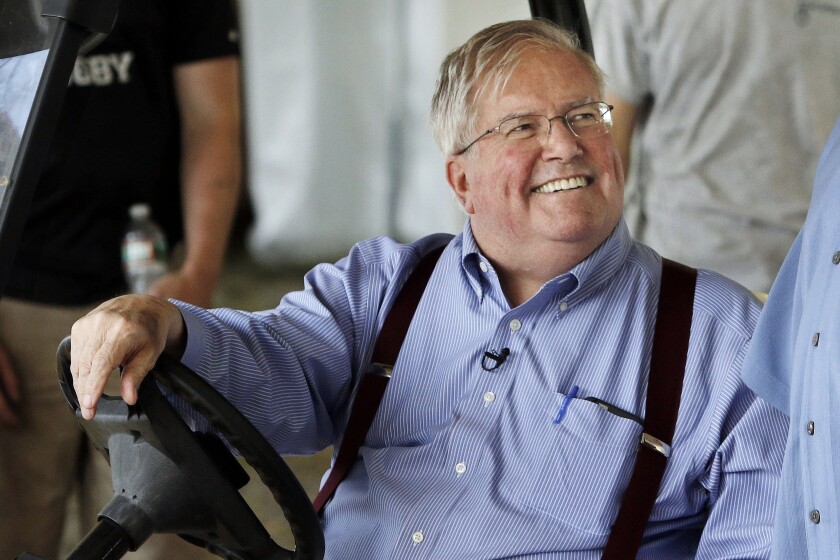 FILE— David Mugar, founder and executive director of the Boston Pops Fireworks Spectacular, smiles while sitting in a golf cart on June 29, 2016, along the Charles River Esplanade in Boston. Mugar, the businessman and philanthropist who transformed the Boston Pops July 4th concert and fireworks show from a small local event into a nationally televised extravaganza, died Tuesday Jan. 25, 2022 at the age of 82, according to his family. (AP Photo/Bill Sikes, File)
