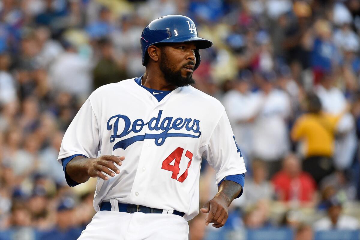 Dodgers second baseman Howie Kendrick scores on a single by catcher Yasmani Grandal during the second inning of a game on April 18 against the Colorado Rockies.