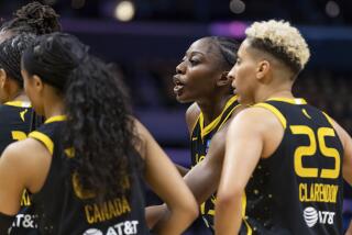 Sparky the mascot of the Los Angeles Sparks interacts with fans