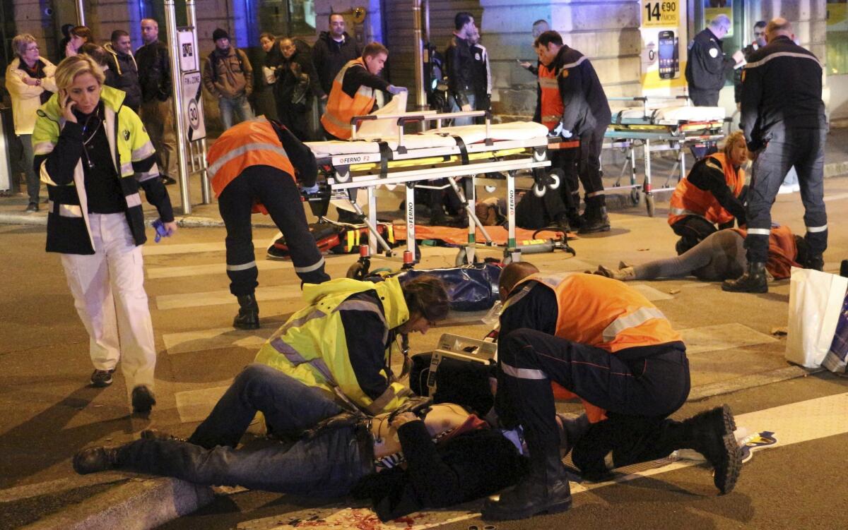 Rescue workers tend to victims after a driver deliberately slammed into pedestrians in Dijon, France, on Dec. 21.