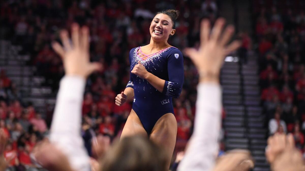 Kyla Ross celebrates her perfect score on the floor exercise during the Pac-12 championship in Salt Lake City on March 23, 2019